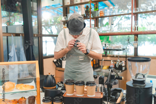 Barista at a coffee shop pr...