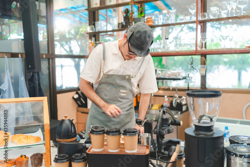 Barista at a coffee shop pr...