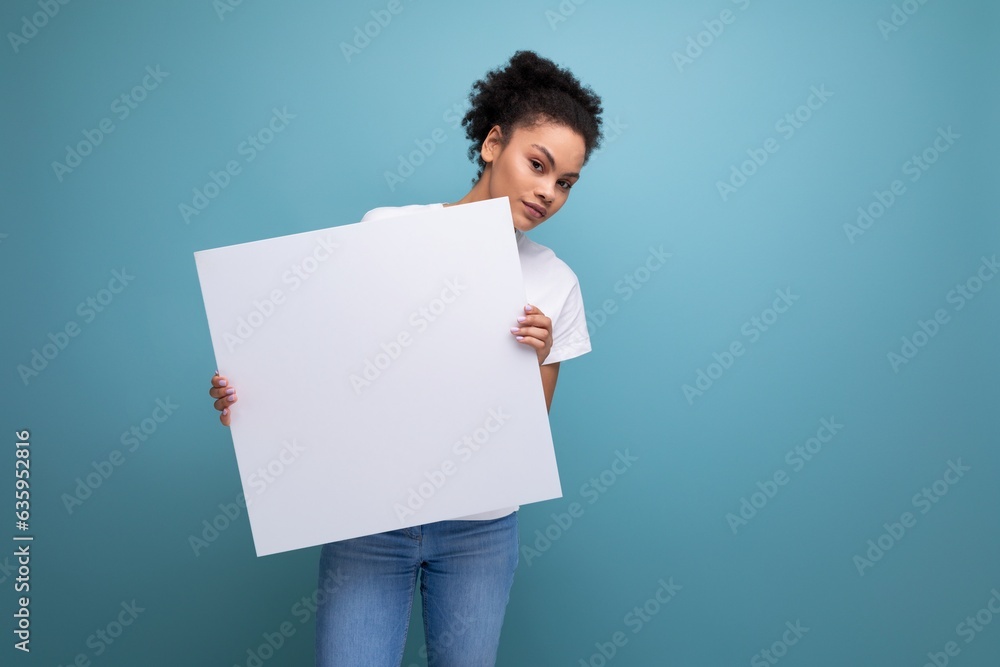young latin brunette female student presenting her study project on a white easel with mockup young latin brunette female student presenting her study project on a white easel with mockup