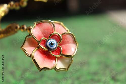 A golden devil eye Flowers in harsh Sunlight on the grass carpet, Vastu or Fang sui Item