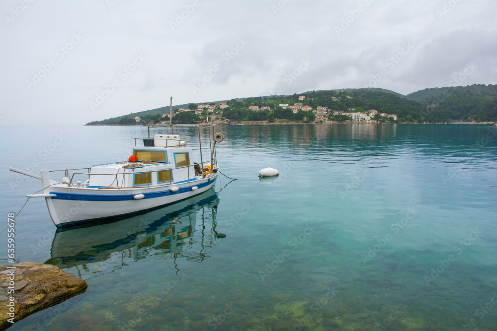 A small boat moored in a bay near Sumartin on Brac Island, Croatia