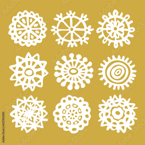 Snowflakes drawn in childish style linear icons set on golden (ID: 635963080)