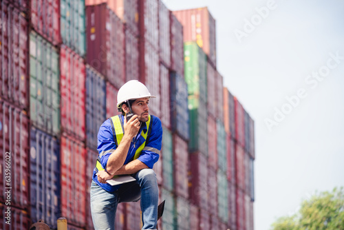 Wallpaper Mural Portrait of Engineers or Technician workers use walkie-talkie commands, communicate to shipping cargo freights colleague with background of cargo containers at shipping container yards and port yards Torontodigital.ca