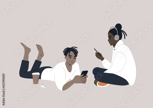 Two adolescents engrossed in their electronic devices, their interaction transitioning from the physical world to the virtual realm of online social media