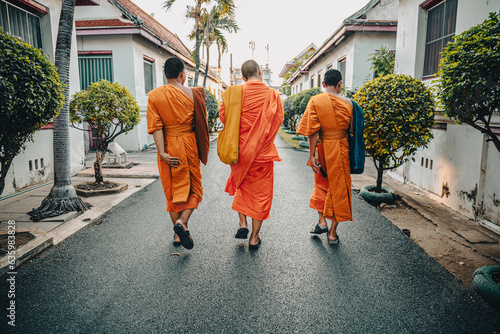 Monks walking down a street in Bangkok