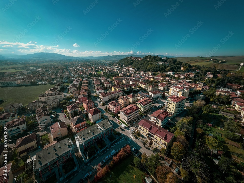 Aerial shot of the beautiful buildings of the medieval Tavoleto village in Italy on a sunny day