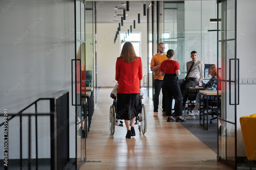 Fototapeta premium A group of young business people in a modern glass-walled office captures the essence of diversity and collaboration, while two colleagues, including an African American businessman in a wheelchair