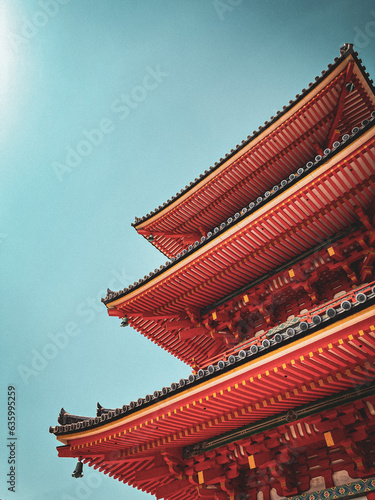 Japanese red pagoda. Blue cloudy sky. Temple roof. Oriental architecture. 