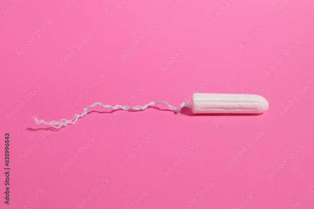 Hygienic female tampon on a pink background, personal care products Hygienic female tampon on a pink background, personal care products