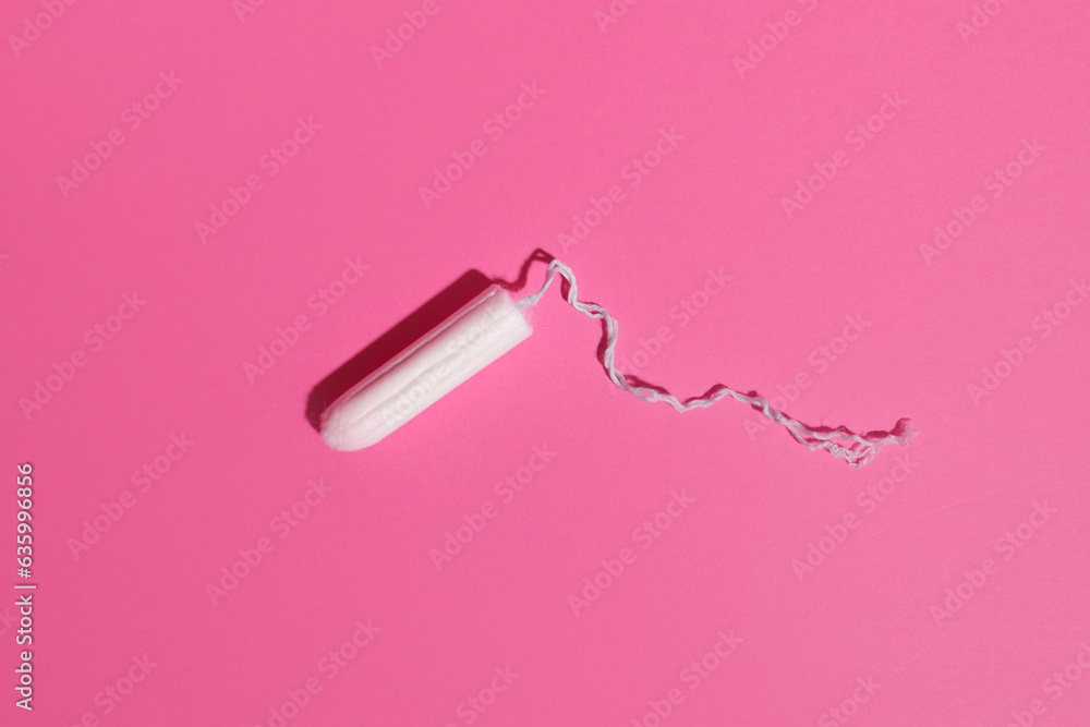 Hygienic female tampon on a pink background, personal care products Hygienic female tampon on a pink background, personal care products