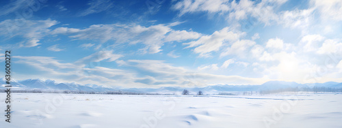 Beautiful Natural Landscape of a Snowfield in a sunny day behind a blue sky with clouds. Generative AI.