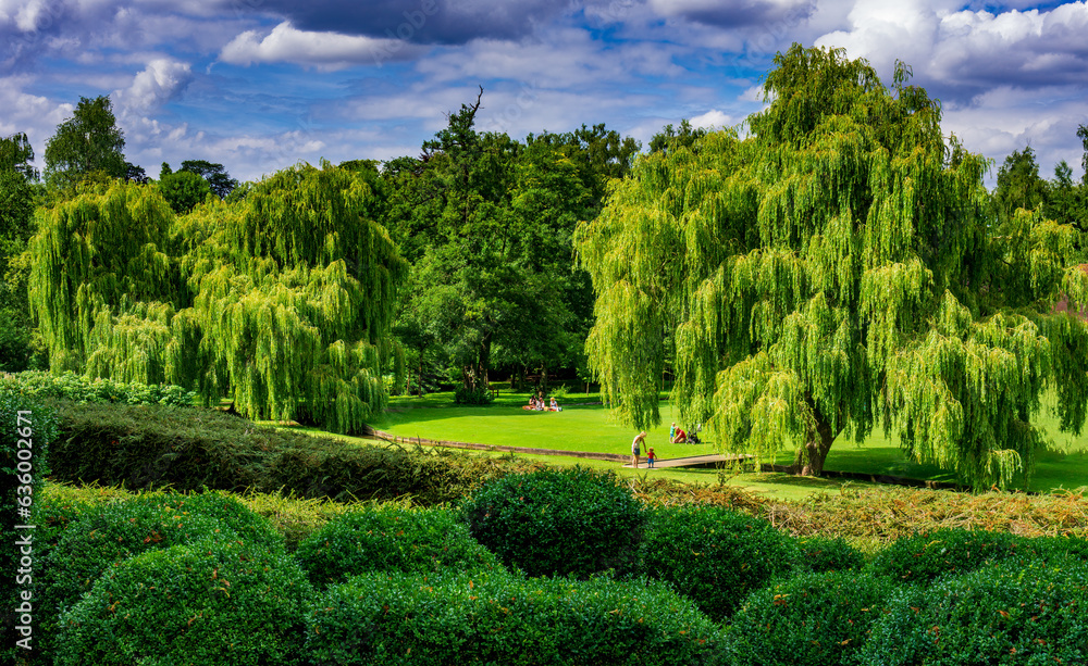 People enjoy a sunny summer day at a park in England People enjoy a sunny summer day at a park in England
