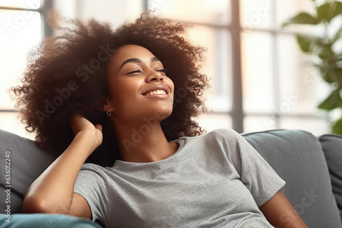 A content and joyful Afro-American woman takes a moment to relax on the sofa at home. Generative Ai, Ai.