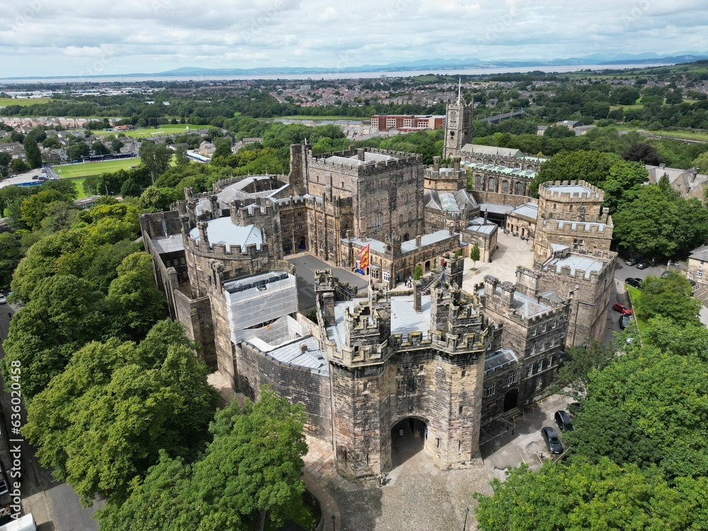 Aerial view of the Lancaster Castle
and the city skyline amidst a lush green landscape of trees