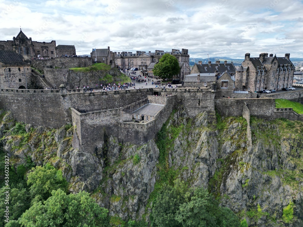 Fototapeta premium Aerial view of a historic Edinburgh Castle, in Scotland surrounded by a large crowd of admirers