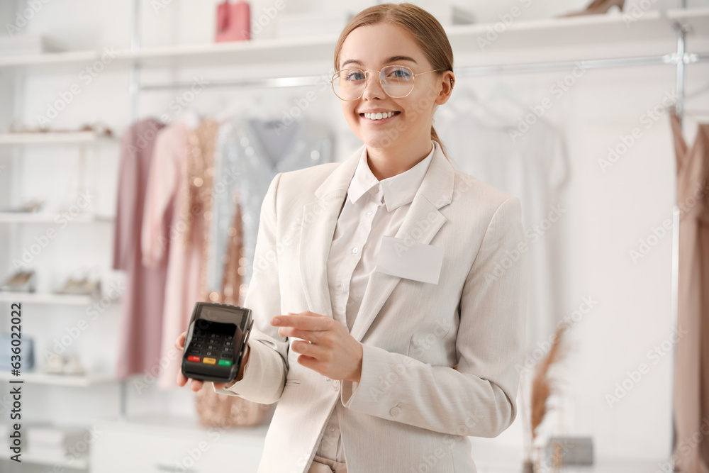 Female seller with payment terminal in boutique Female seller with payment terminal in boutique