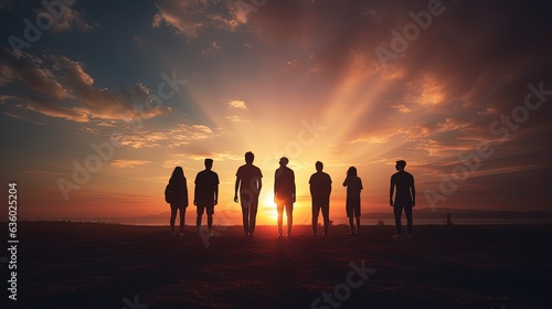 Group of friends silhouetted against a sunset