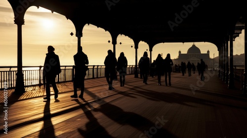 Dark figures of individuals on Scarborough pier. silhouette concept