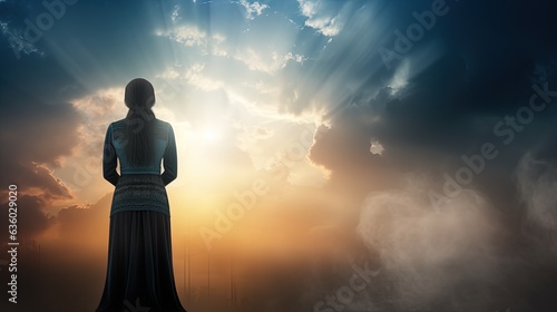 Woman praying with sky backdrop. silhouette concept