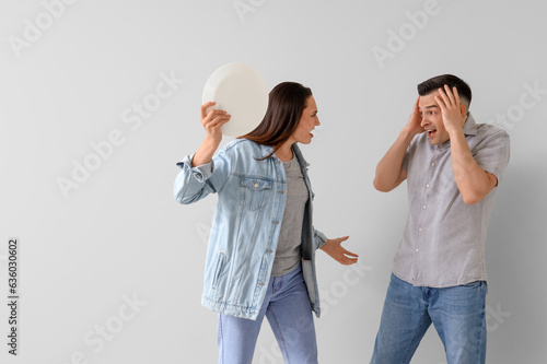 Angry young woman with plat...