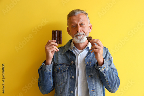 Mature man eating tasty cho...