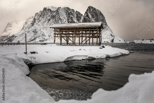 Construction on snowy shore of lake photo