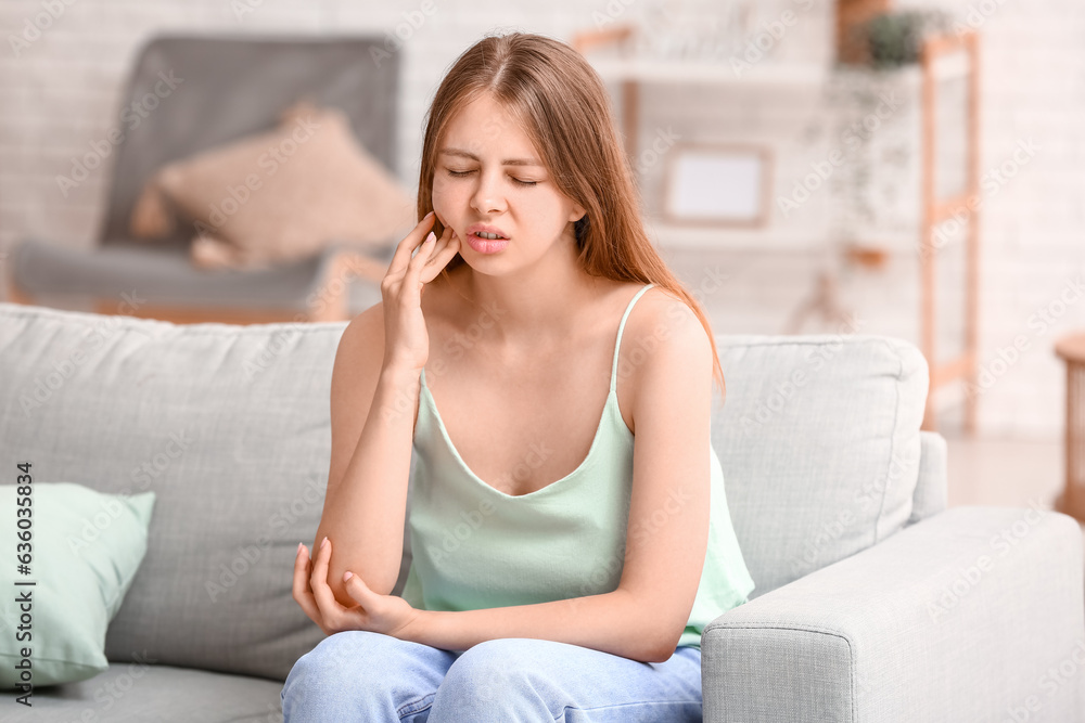 Young woman suffering from toothache at home Young woman suffering from toothache at home