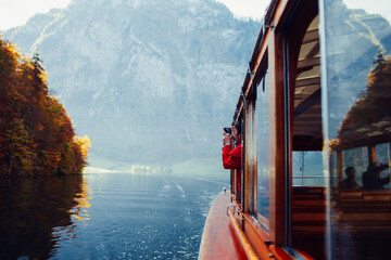 Man photographing Königsee lake in Alps in fall 