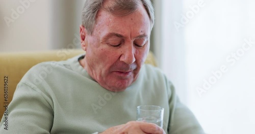 Drinking water, senior man and Parkinson disease or tremor with trembling hands on a home sofa. Sick elderly person with a disability, glass and neurology, muscle or shaking illness in retirement photo