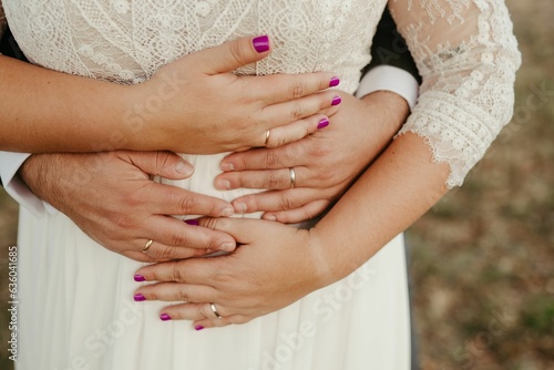 a bride and groom with two wedding rings on their hands