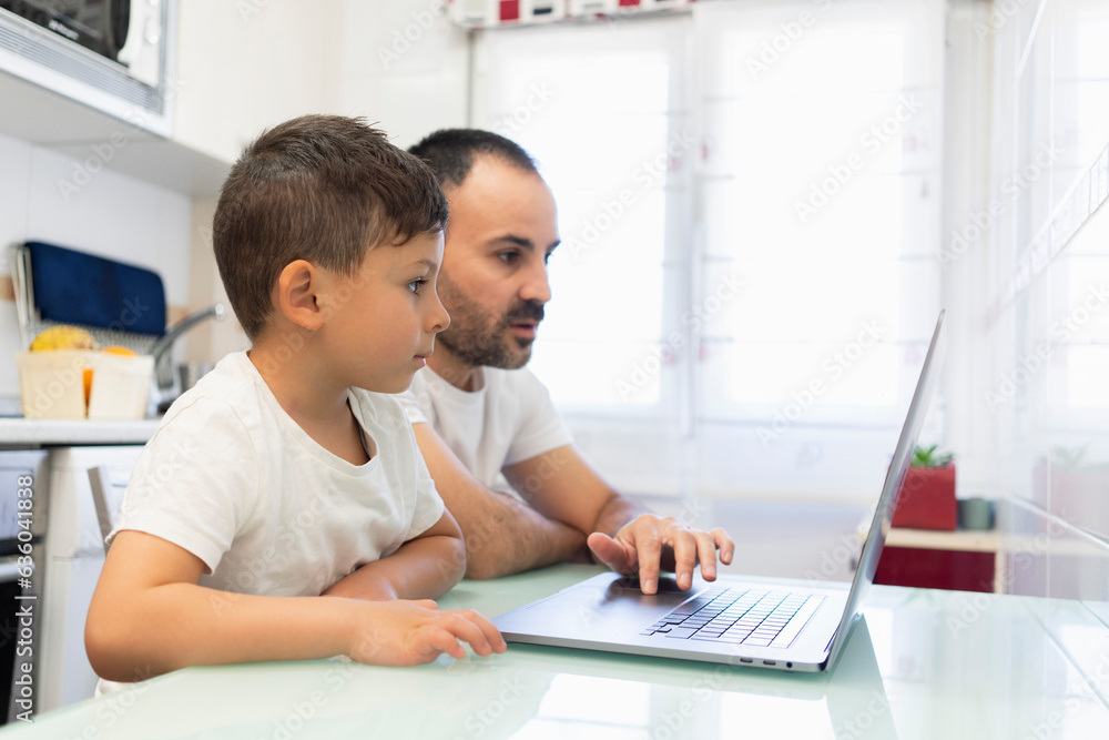 Father and son using laptop at home Father and son using laptop at home