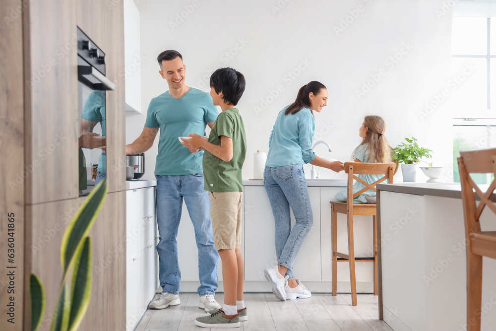 Little children with their parents in kitchen
