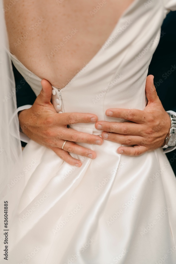 Obraz premium a man showing his hands behind his belt as a woman in a dress stands with