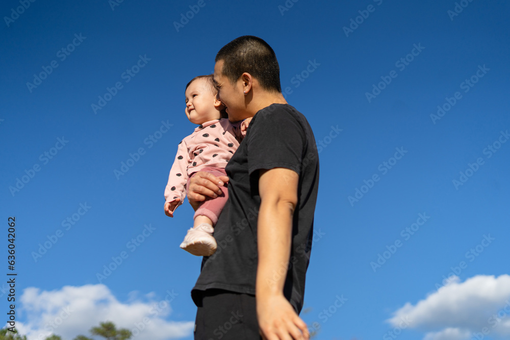 father with daughter in his arms in nature father with daughter in his arms in nature