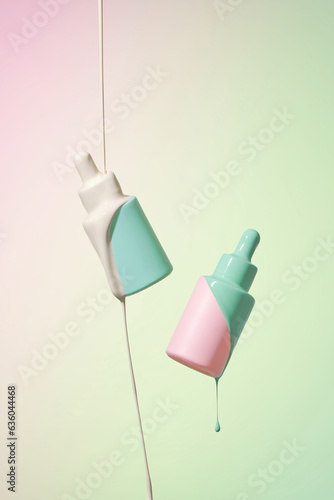 Milk falling on serum bottle on multicolor background photo