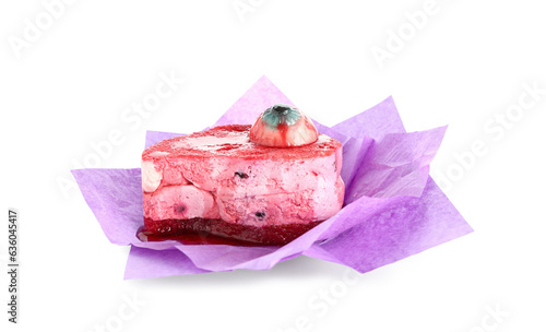 Delicious fruit cake with candy in paper for Halloween celebration on white background