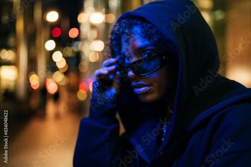 Cool black female in hoodie on night street photo