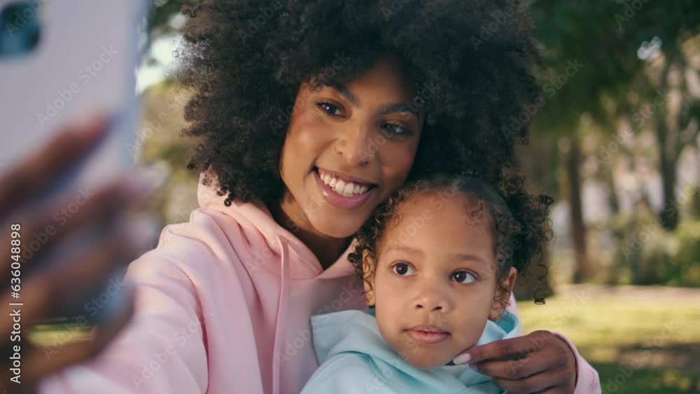 Mother child taking photo together on phone at beautiful green meadow close up. Mother child taking photo together on phone at beautiful green meadow close up.