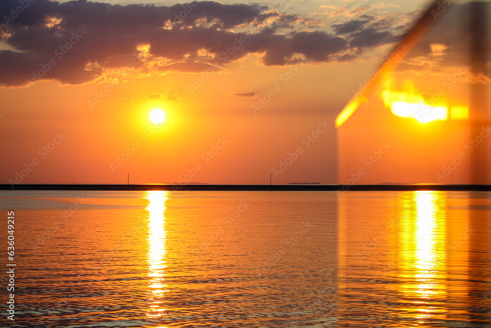 Beautiful sunset over sea coast. Orange yellow sky with majestic clouds ...