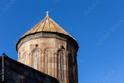 Sapara Monastery bell tower, orthodox church building facade made of red and yellow stone and rich carved ornamentation around the windows, Georgia. photo