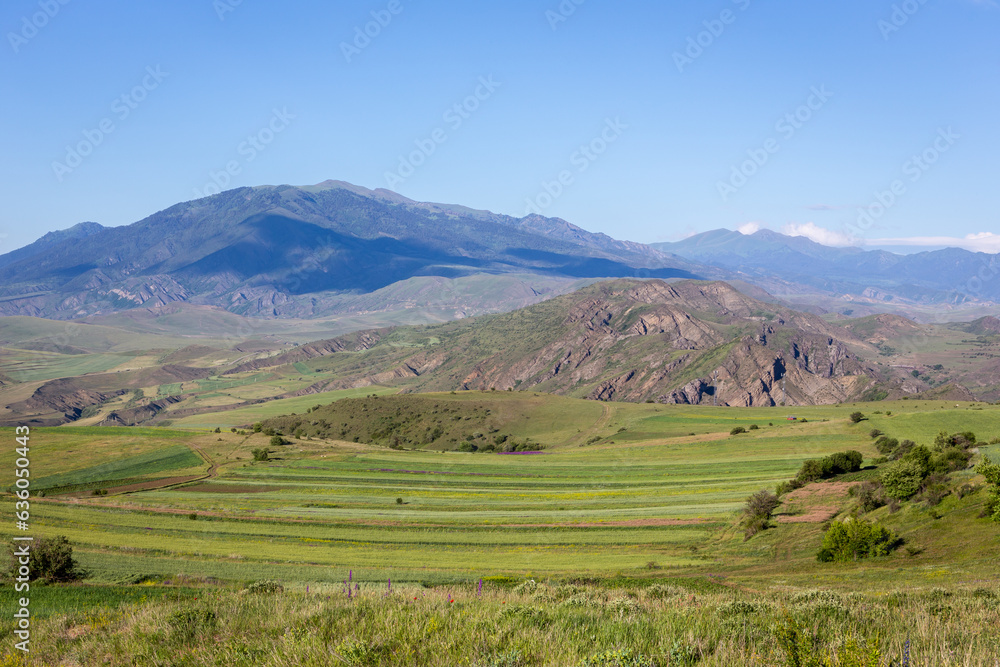 Green hills of Lesser Caucasus mountains in Samtskhe - Javakheti region in Georgia with agriculture fields and grasslands.