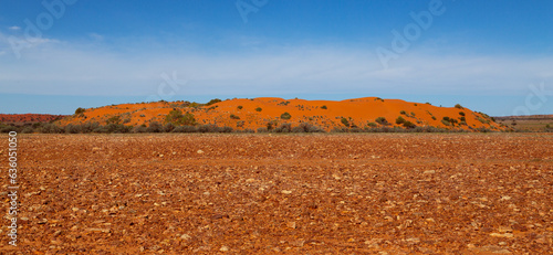 A red sand dune rising above a gibber or stony plain in the Stony Desert in central Australia