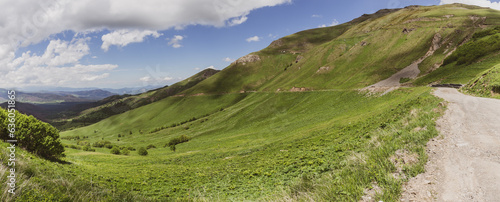 Dangerous M-20 dirt gravel road to Tskhratskaro Pass, Georgia, with Trialeti (Caucasus) green mountains panorama, summer. photo