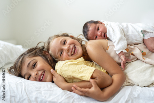 Three sibling on the back of each other.