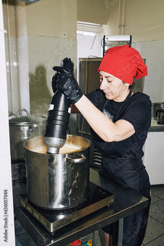 chef holding an immersion blender
