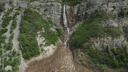 Wide aerial drone pull back from Bridal Veil Waterfall reveals avalanche damage photo