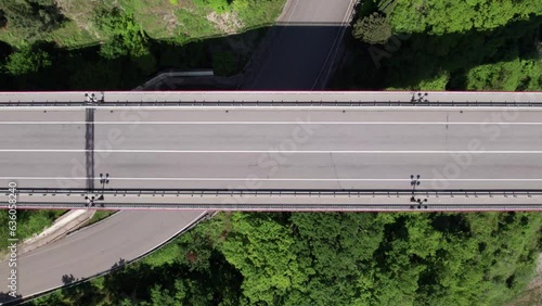 The Zubova Schel Viaduct is a road bridge, Dzhubga - Adler federal road. Aerial view of car driving along the winding mountain road in Sochi, Russia.