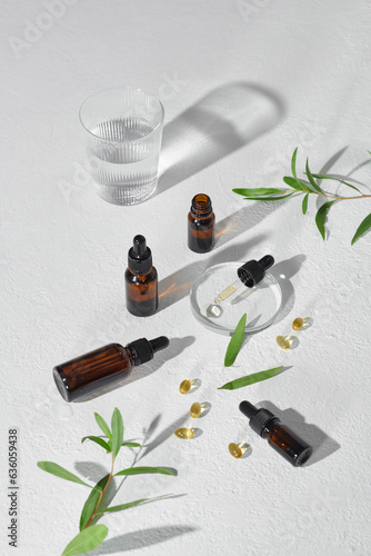 Mockup glass bottles and tea tree leaves