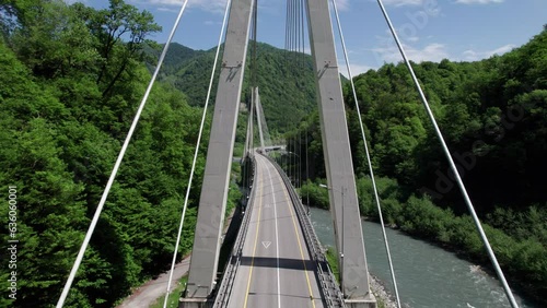 Cable-Stayed Bridge on the Adler-Krasnaya Polyana motorway. Aerial view of car driving along the winding mountain road in Sochi, Russia.