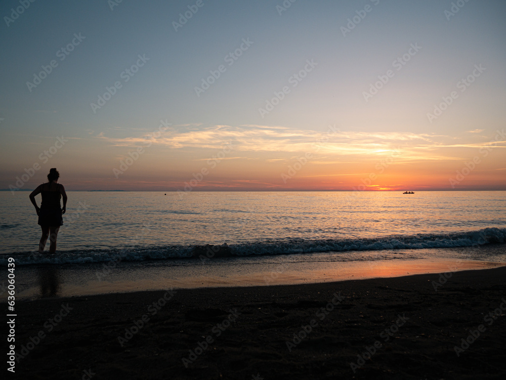 Person Boy Girl looking at horizon during sunset in italy at the mittelmeer Sea Enjoy dawn at mare
